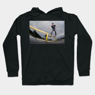 Skateboarder doing a board slide Hoodie